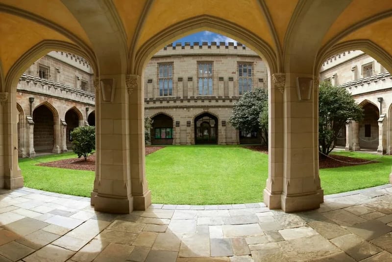 The gothic sandstone cloisters and green quadrangle of the University of Melbourne's Old Quad